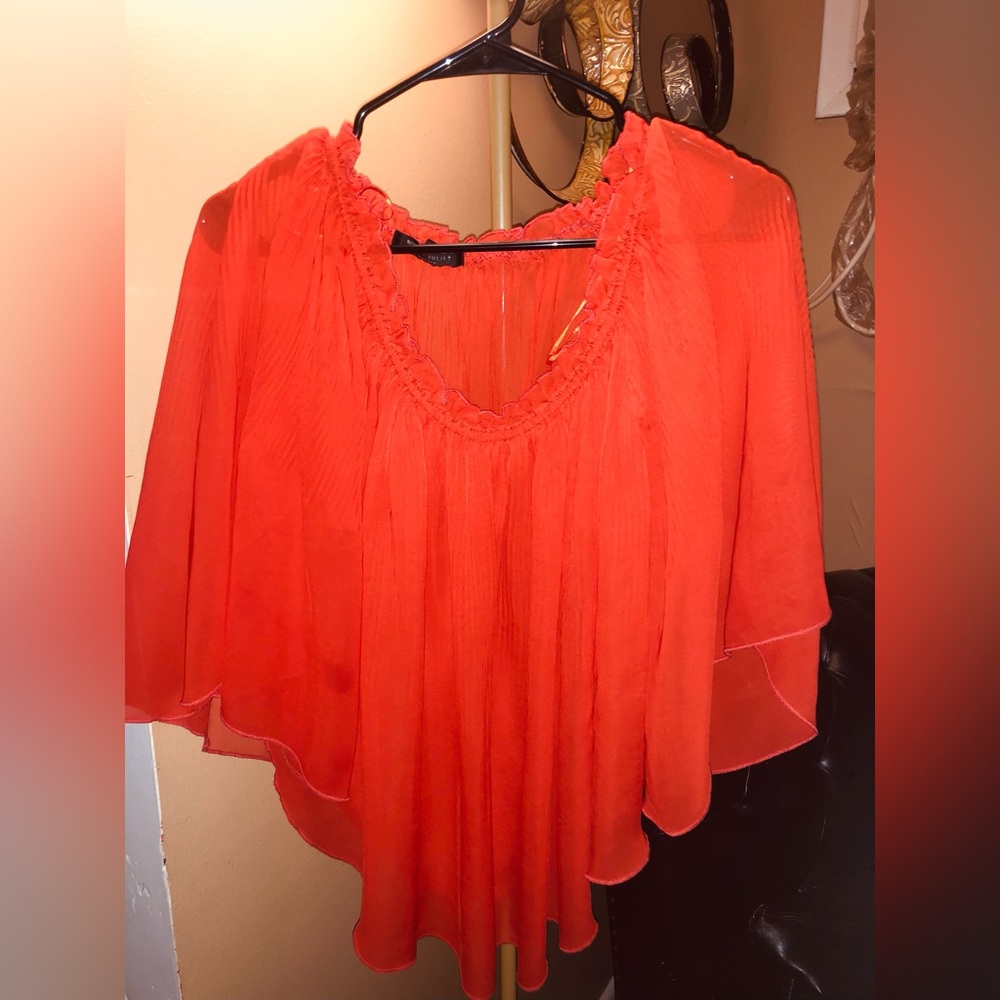 Pretty blouse to wear with a pair of jeans or dress slacks! Light material.